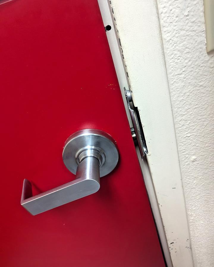 Commercial lever on a red steel door